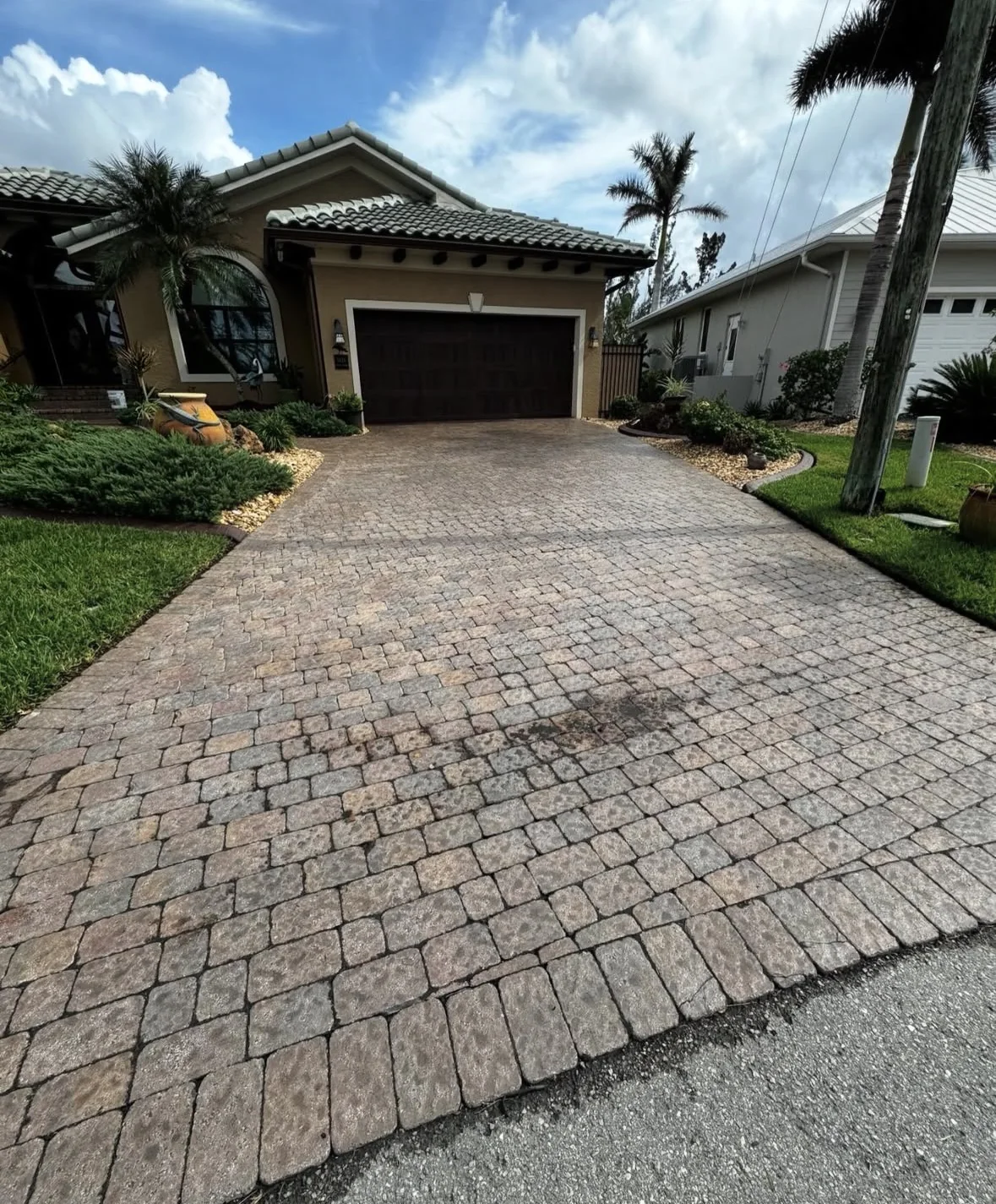 Before: faded and weathered paver driveway